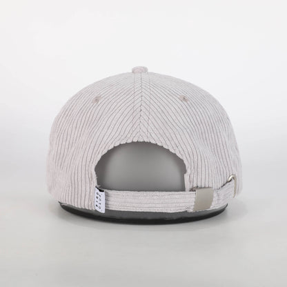 A back view of a recycled corduroy hat from Bird Club, showcasing the adjustable strap and metal buckle. The hat's light gray corduroy fabric adds a stylish, textured look, and the small Bird Club tag is visible on the strap. While the embroidered mandarin duck logo is not seen from this angle, the hat remains part of a sustainable brand collection, emphasizing eco-friendly materials and a passion for ornithology. 