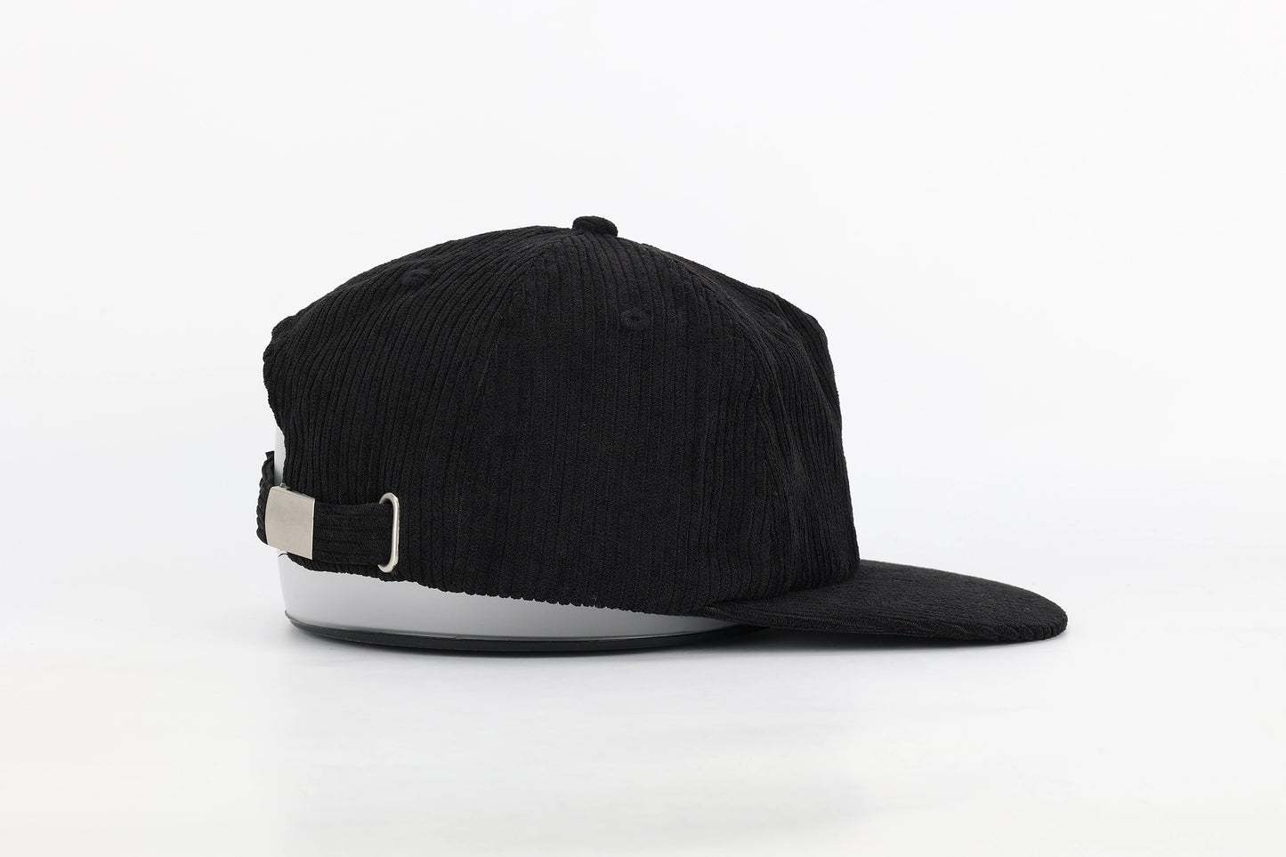 Side view of a black corduroy hat with an adjustable strap and sleek metal buckle, blending fashion and sustainability. A perfect eco-friendly gift for bird lovers.