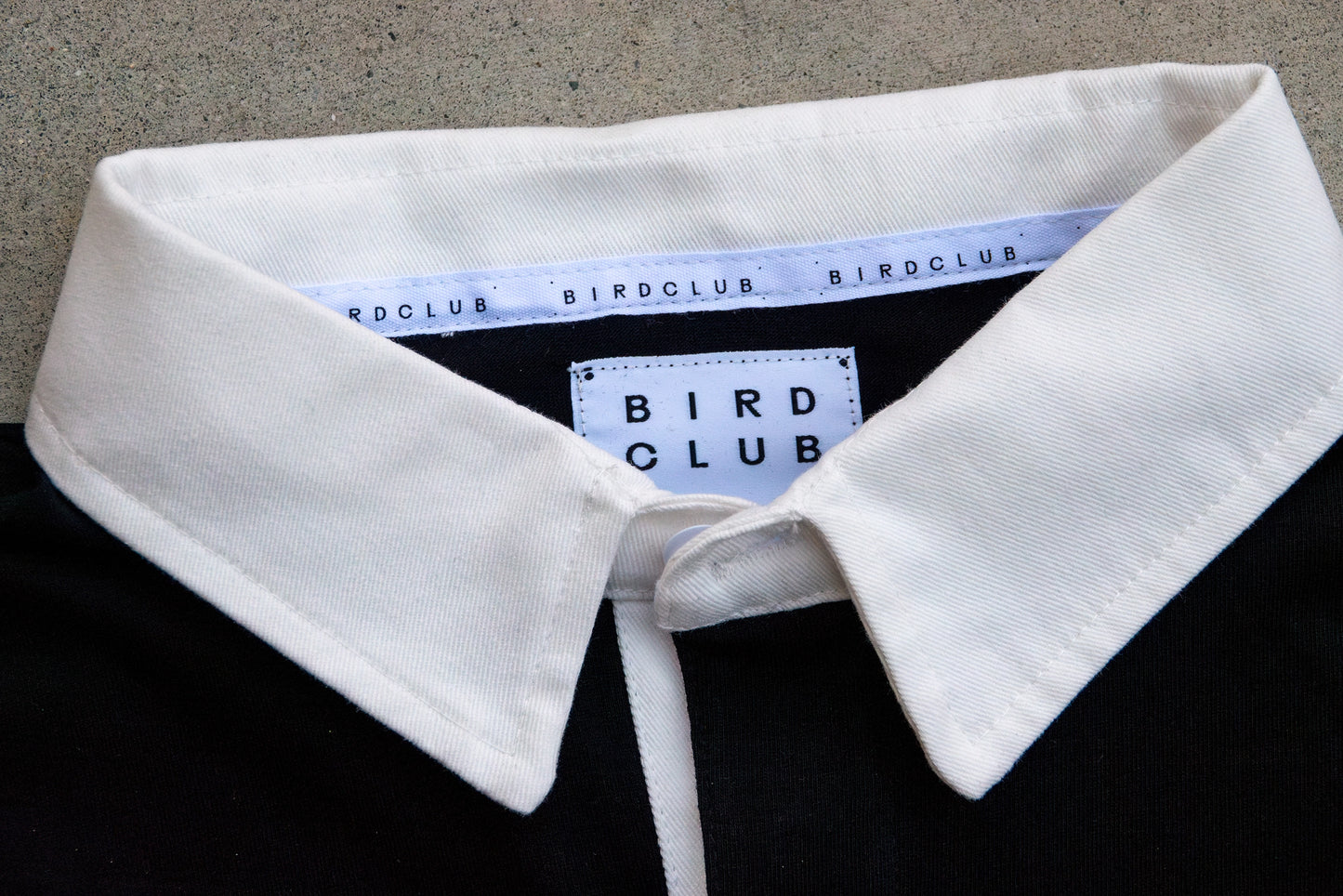 Close-up view of the Bird Club branding on the ornithology shirt collar, featuring high-quality stitching. An ideal choice for bird watcher gifts and eco-conscious fashion lovers.